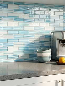 White Cabinets Gray Speckled Countertops with Ocean Wave Blue Glass Subway Tile BA5563