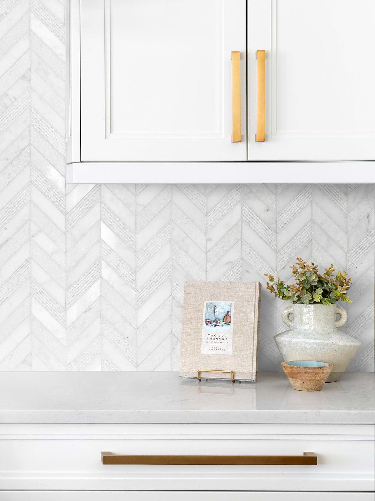 white marble countertop kitchen cabinets with white chevron marble tile BA631613
