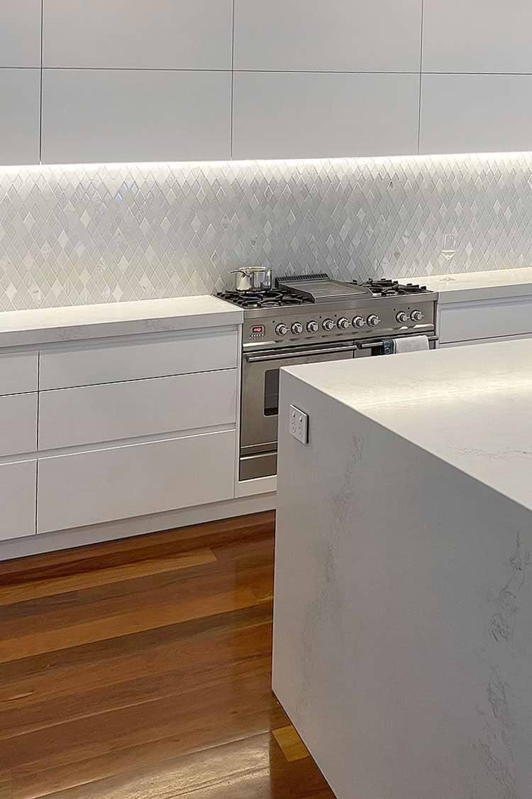 modern white kitchen white backsplash