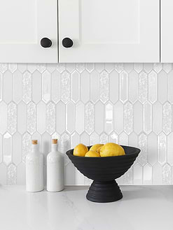 white glass backsplash tile with quartz countertop