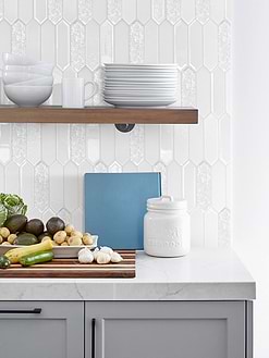 white glass mosaic backsplash tile with gray cabinet and quartz countertop