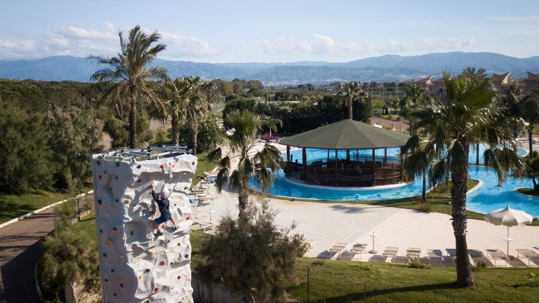 climbing wall with swimming pool in background