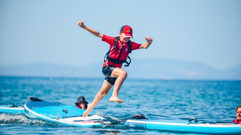 Kids' club enjoying the paddle boards at Vounaki Beach Club