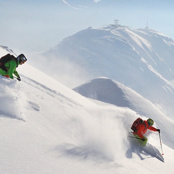 Skiers and Snowboard on a powder run