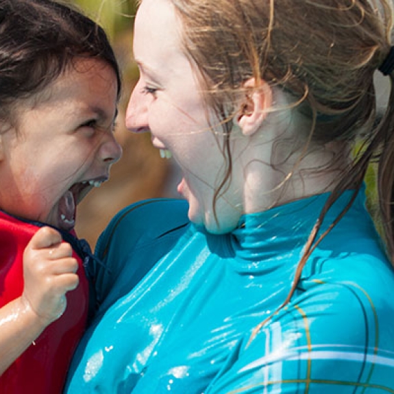 young girl and nanny playing in the pool