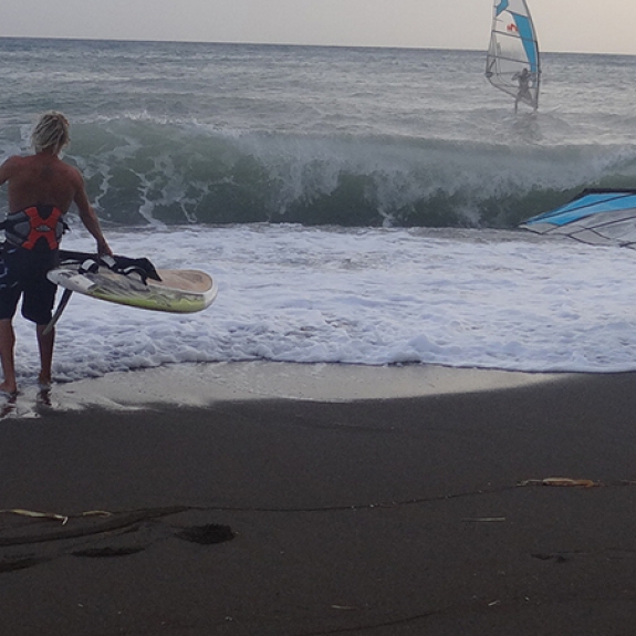 two people about to go windsurfing