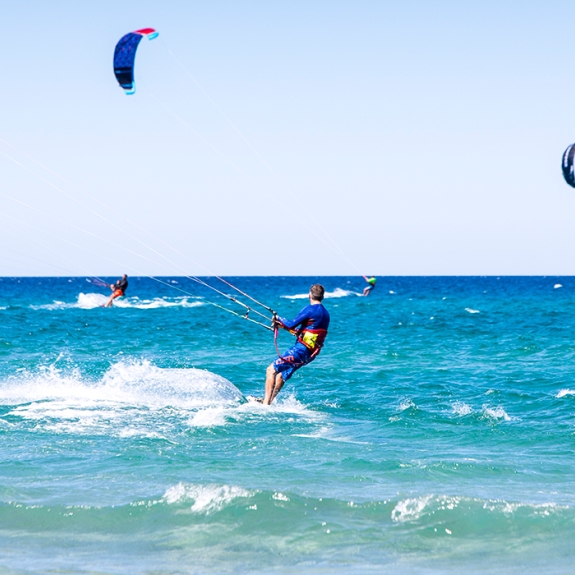 People kitesurfing on holiday in Sardinia