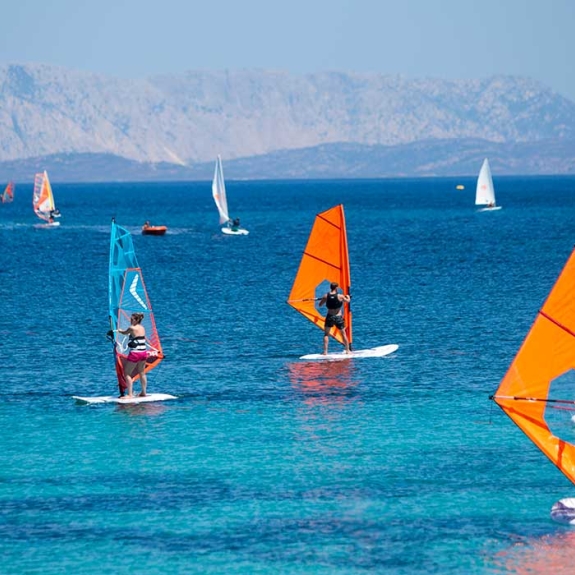 Group of beginners windsurfing