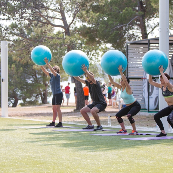 Group of people doing fitness with balance balls