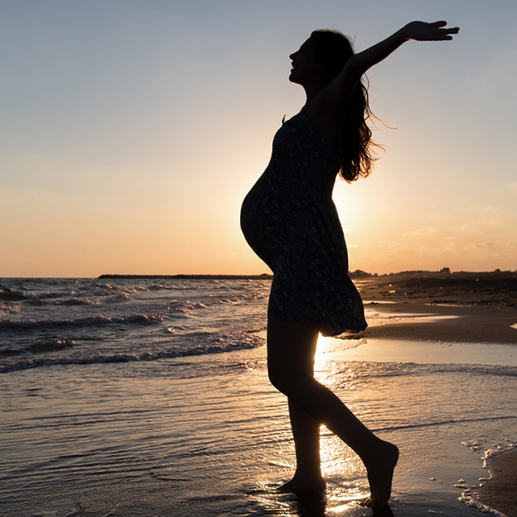 Pregnant woman on beach