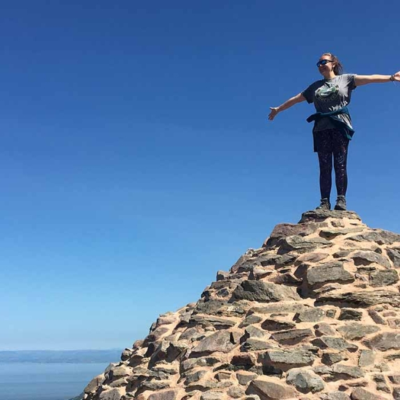 Girl standing in top of pile of rocks