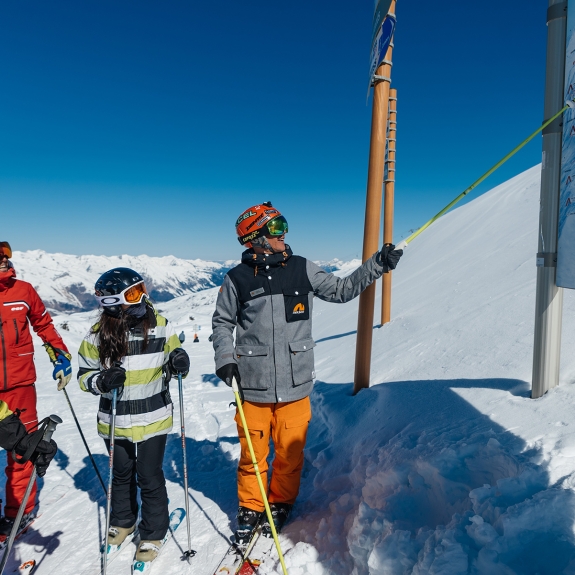 Neilson mountain expert showing guiding group around the mountain
