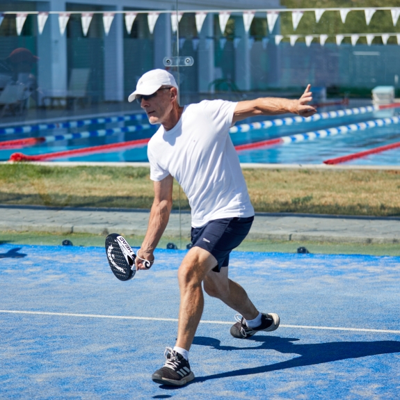 Padel tennis with lanes pool in the background at Levante Beach Club
