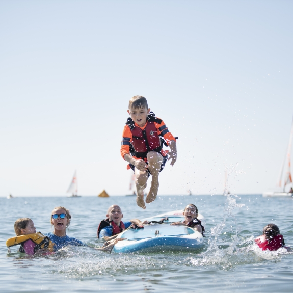 Fun with the kids' club on paddle boards at Levante Beach Club