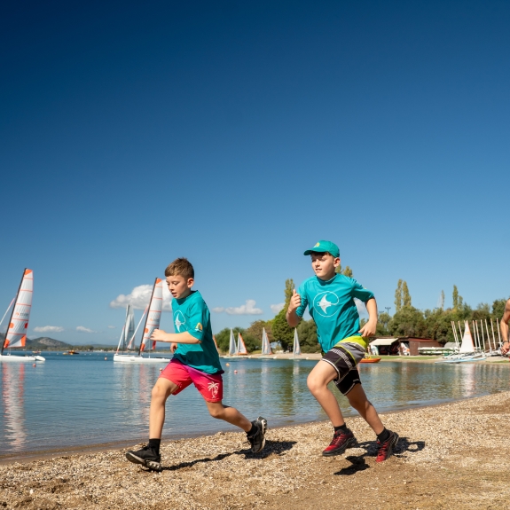 Kids running on a beach