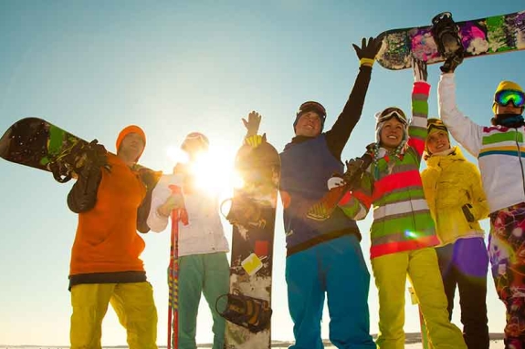 group of young skiers and snowboarders