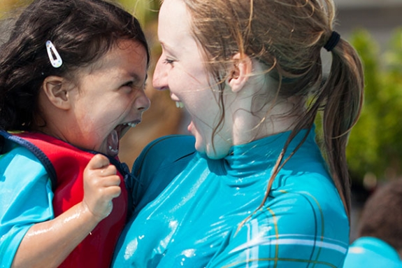 young girl and nanny playing in the pool