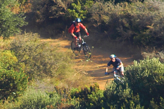 Two people mountain biking in countryside of Lefkada, Greece
