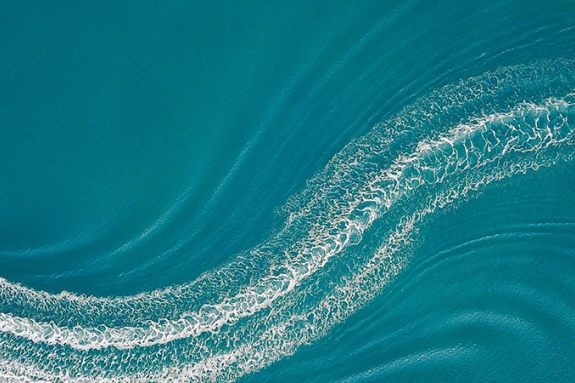 Aerial image of wakeboarder and speed boat