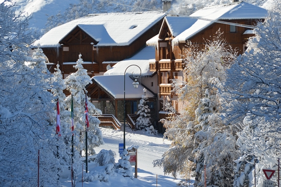 View of a snow covered Neilson Mountain Collection hotel