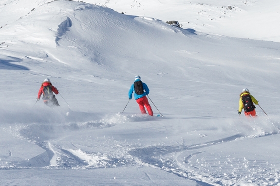 Group of people skiing in powder