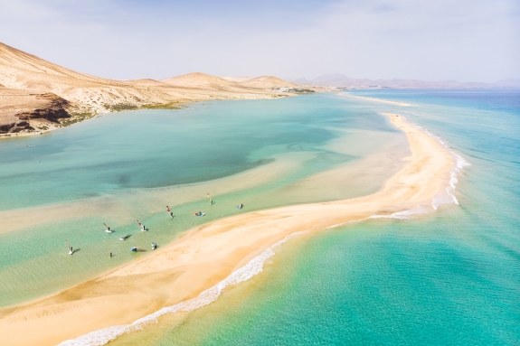 Aerial view of people windsurfing in shallow water