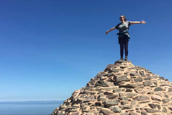Girl standing in top of pile of rocks