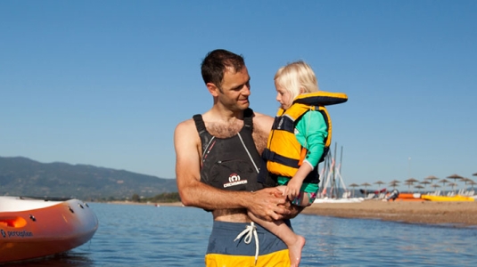 Man and young girl in sea