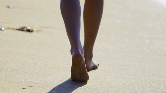 woman walking along the beach