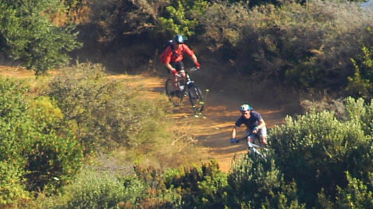 Two people mountain biking in countryside of Lefkada, Greece