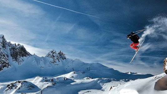 skier jumping from a Cliff drop