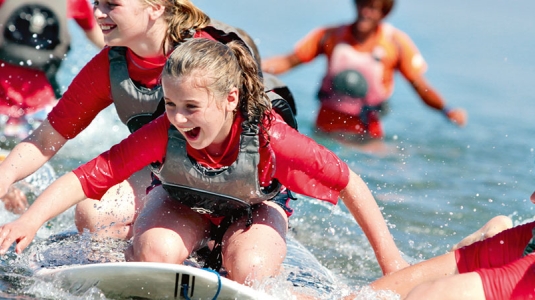 Group of children playing and splashing in sea