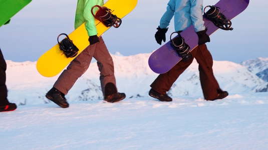 snowboarders walking with their boards