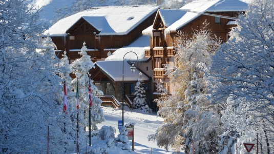 View of a snow covered Neilson Mountain Collection hotel