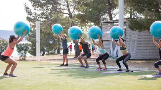 Group of people doing fitness with balance balls