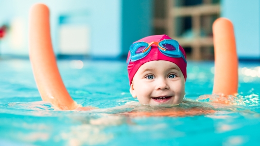 Toddler learning to swim