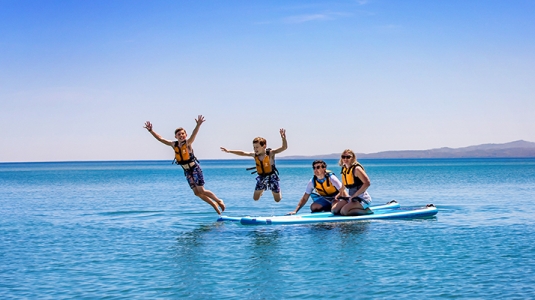 little girl sitting on dads shoulders