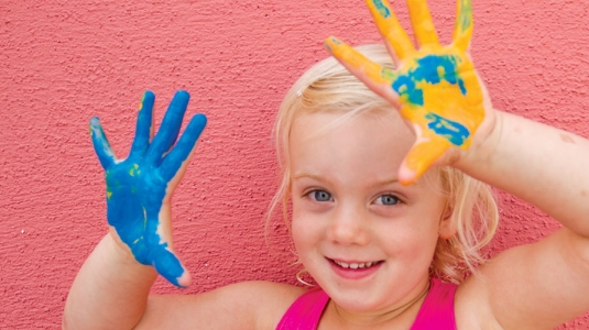 A child with paint on their hands