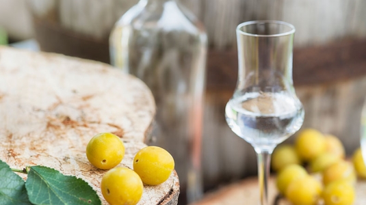 Fruits next to a glass