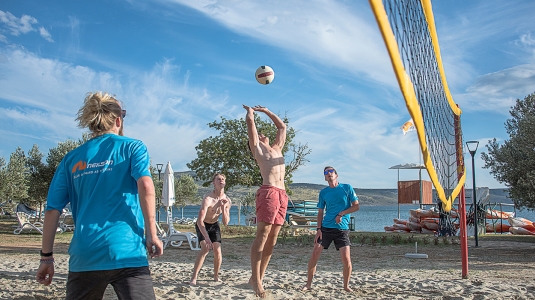 People playing volleyball on the beach