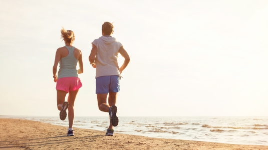 couple running on the beach