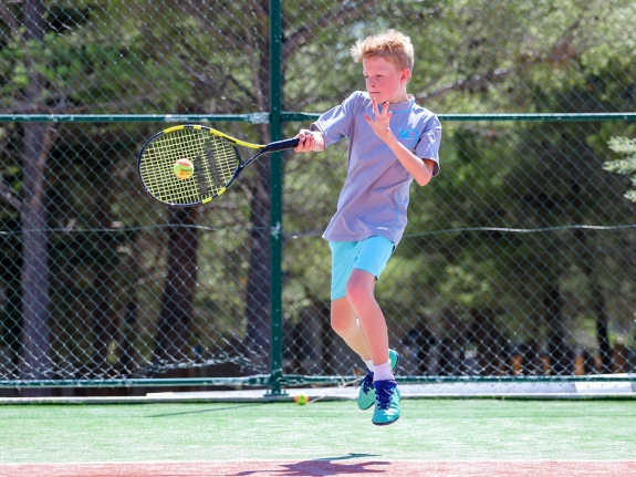 child playing tennis