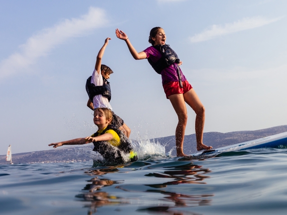 kids playing on a paddle board
