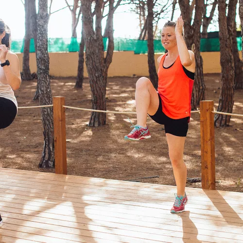 two women and instructor doing a HIIT class