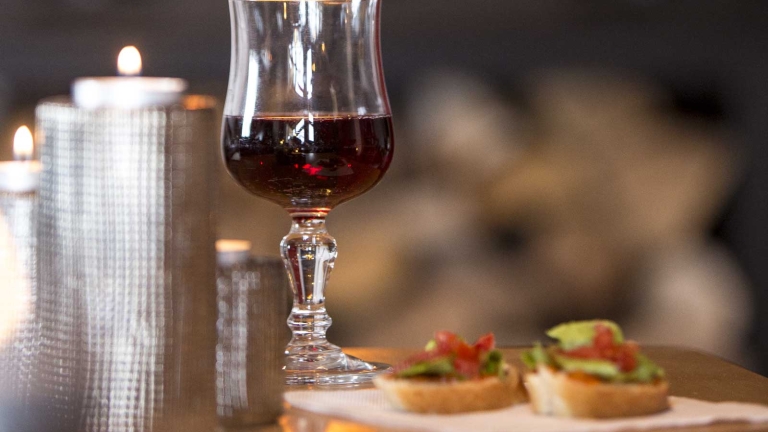 Enjoy a glass of wine by the wood burning stove