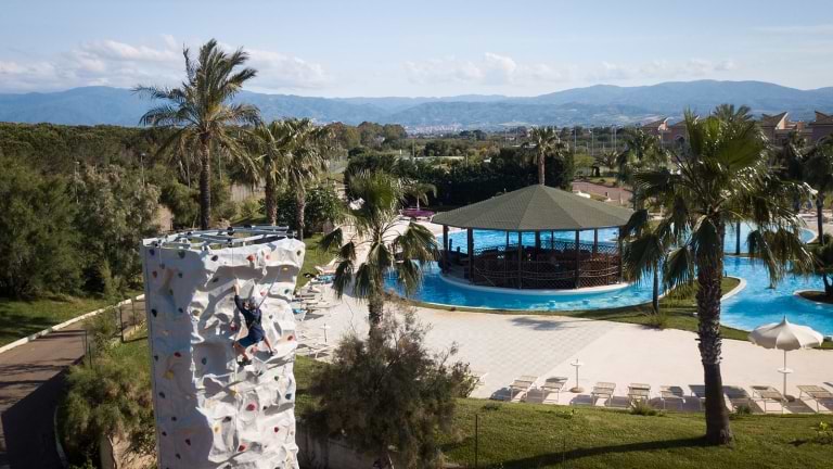 climbing wall with swimming pool in background