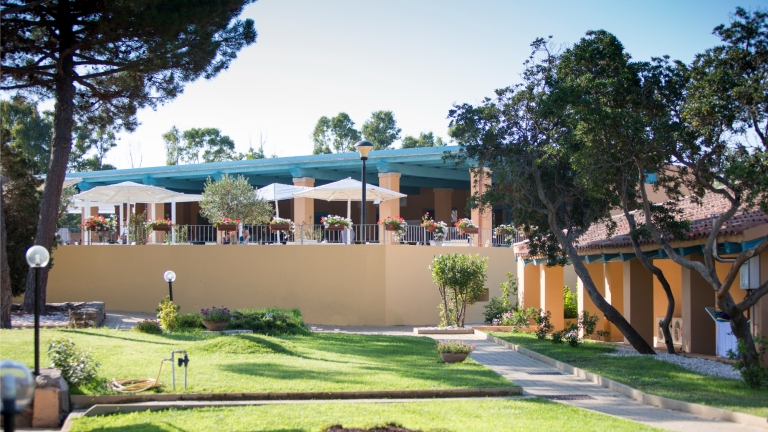 Restaurant terrace and room exteriors at Baia dei Mori Beach Club