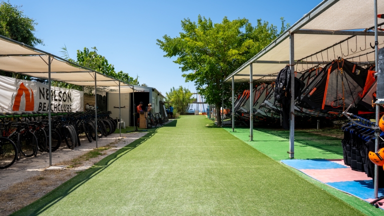 Windsurf and bike racks at Cosmos Beach Club