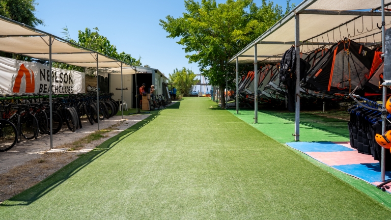 Windsurf and bike racks at Cosmos Beach Club