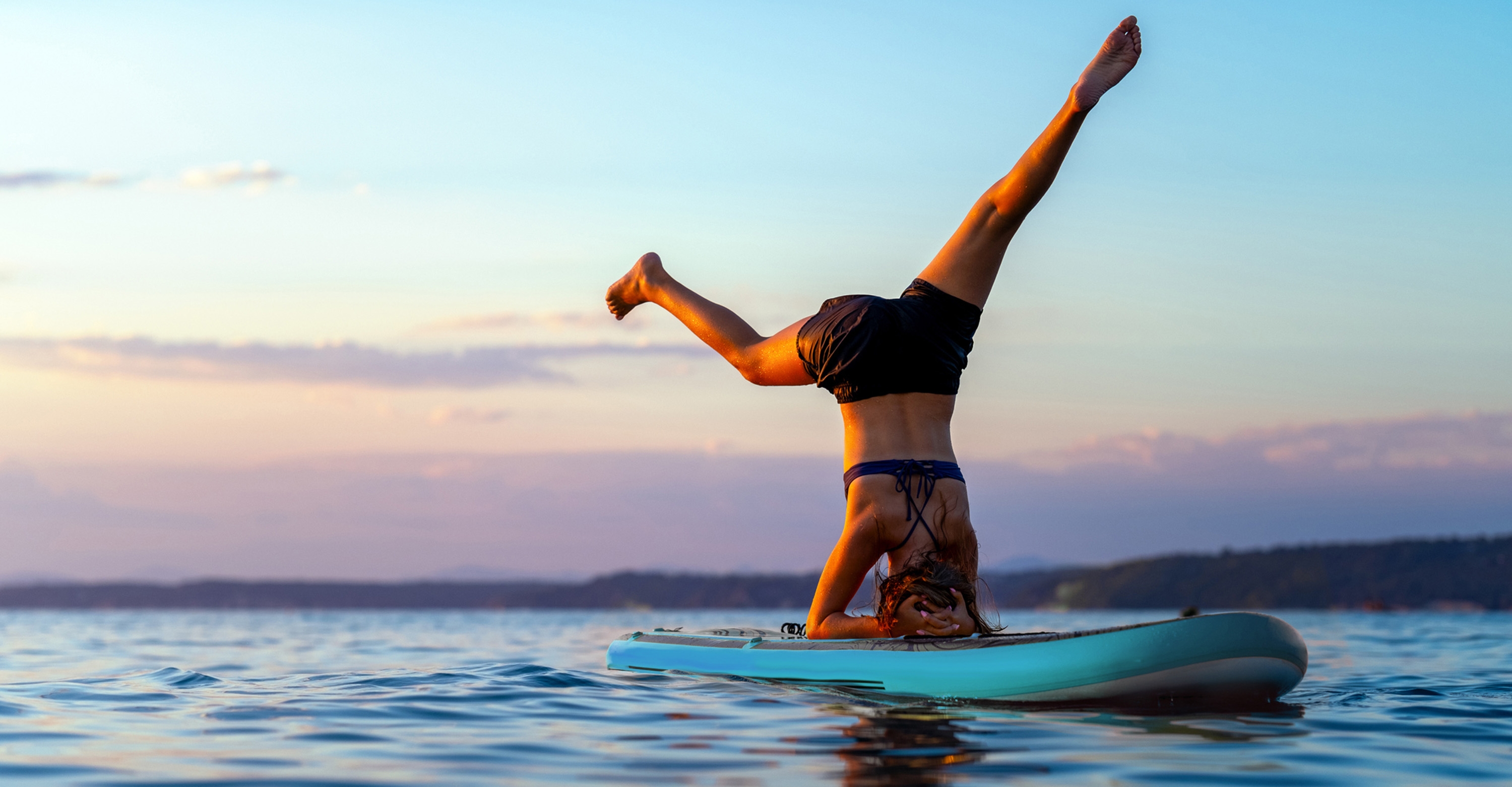 woman doing yoga on a SUP